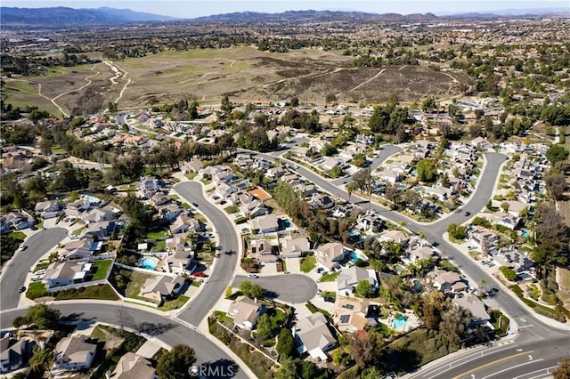 drone / aerial view featuring a residential view and a mountain view