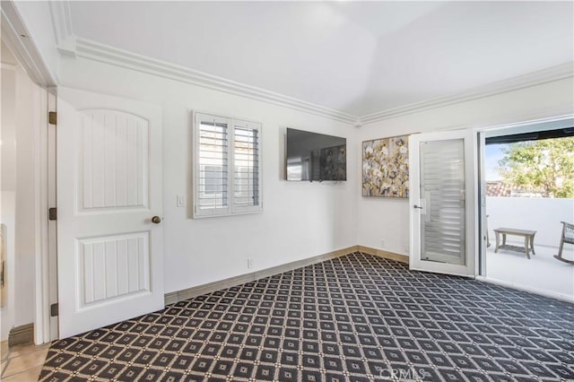 unfurnished room with ornamental molding, plenty of natural light, and baseboards