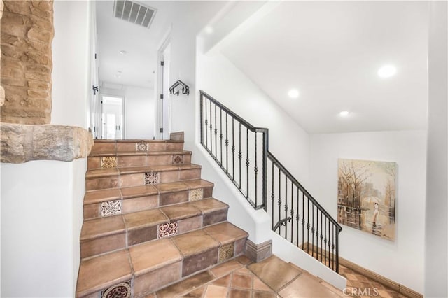 staircase featuring recessed lighting, visible vents, and baseboards