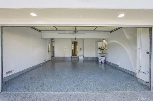 garage with recessed lighting, visible vents, and baseboards