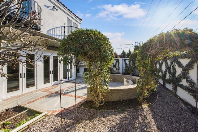 view of yard featuring a patio, french doors, and fence