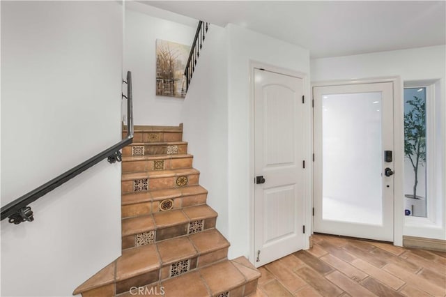 stairs featuring wood finished floors