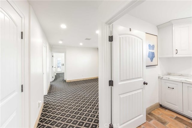 hall featuring recessed lighting, visible vents, and baseboards