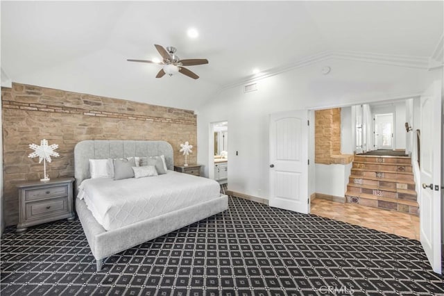 bedroom with ceiling fan, baseboards, vaulted ceiling, ensuite bath, and crown molding