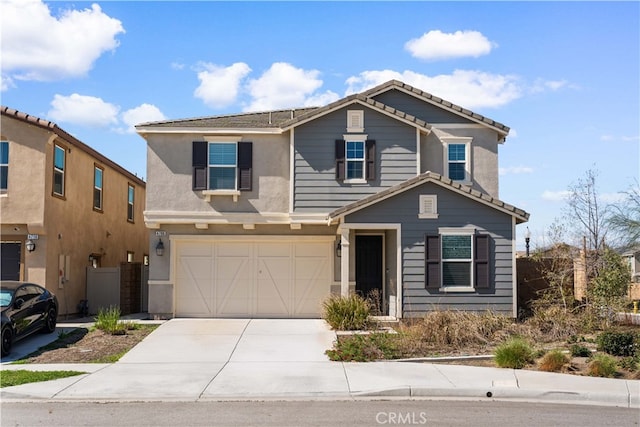 traditional-style house with an attached garage, concrete driveway, and stucco siding