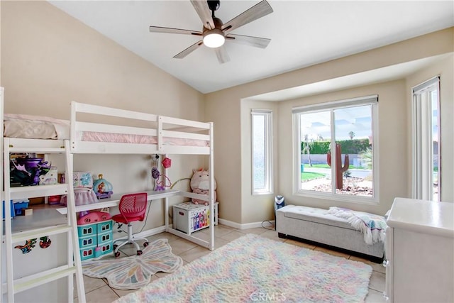 bedroom with vaulted ceiling, tile patterned flooring, a ceiling fan, and baseboards