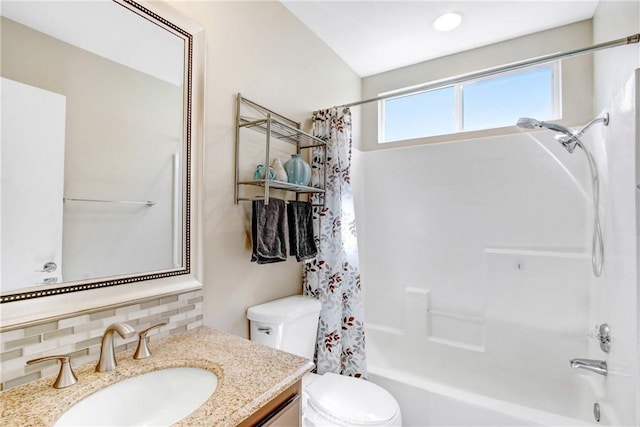 bathroom with toilet, vanity, backsplash, and shower / bath combo with shower curtain