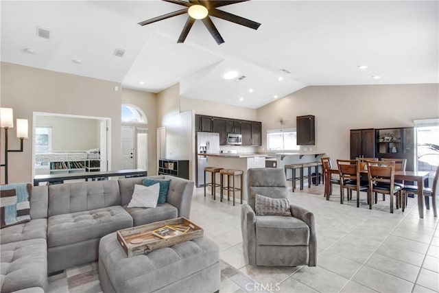 living room featuring recessed lighting, visible vents, vaulted ceiling, and light tile patterned floors