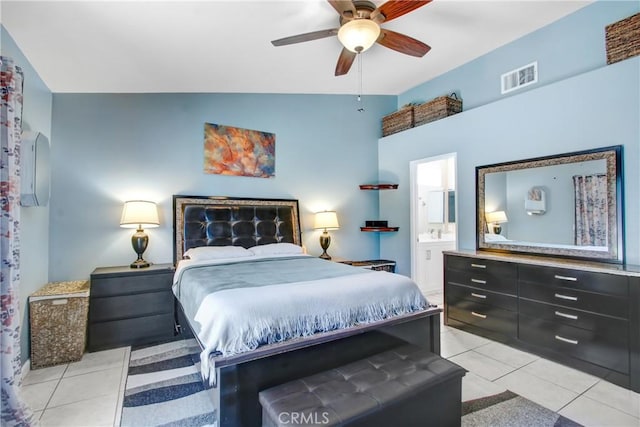 bedroom with light tile patterned floors, visible vents, a ceiling fan, vaulted ceiling, and ensuite bath