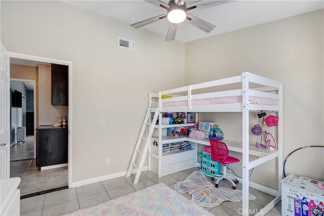 tiled bedroom featuring a ceiling fan, visible vents, and baseboards