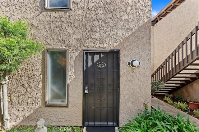 property entrance featuring stucco siding