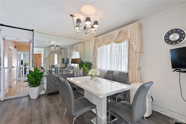 dining room featuring wood finished floors and an inviting chandelier