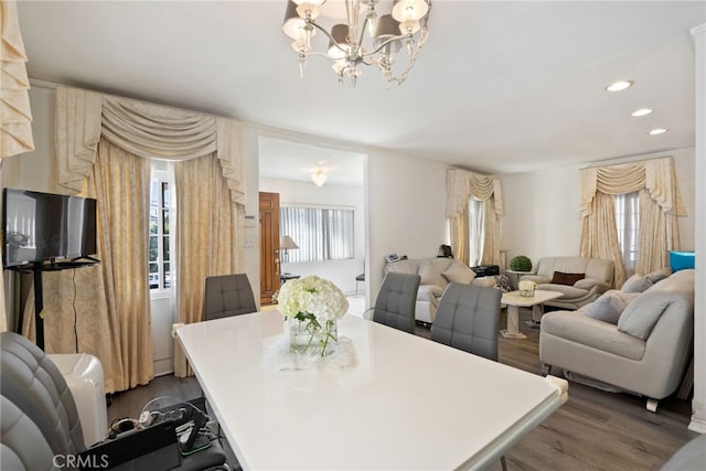 dining space featuring a notable chandelier, dark wood finished floors, and recessed lighting