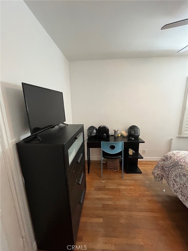 bedroom featuring light wood finished floors and baseboards