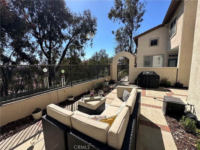 view of patio / terrace with a grill, a gate, fence, and an outdoor living space