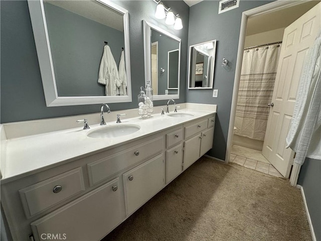 full bathroom with tile patterned floors, visible vents, a sink, and double vanity