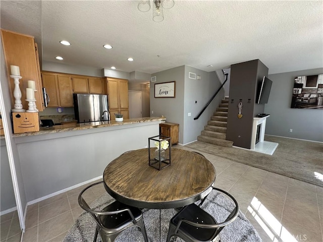 dining area featuring stairs, light tile patterned floors, a textured ceiling, and recessed lighting