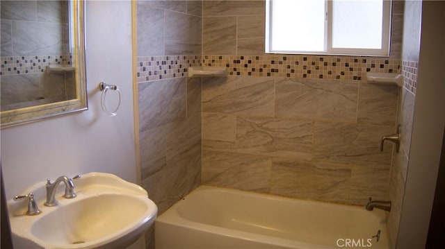 bathroom featuring a sink and bathing tub / shower combination