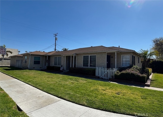 single story home featuring fence, a front lawn, and stucco siding