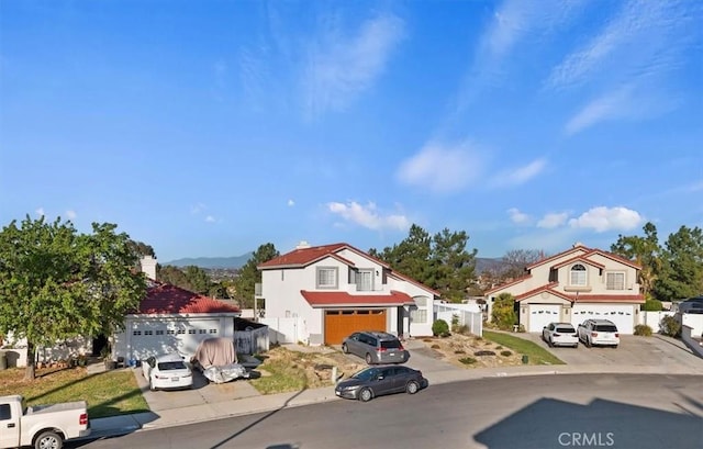 mediterranean / spanish-style house featuring a garage and concrete driveway