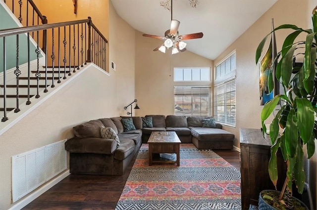 living room featuring ceiling fan, stairs, visible vents, and wood finished floors