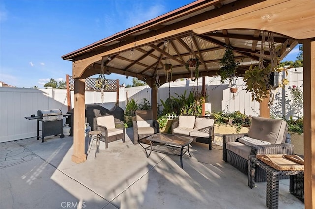 view of patio / terrace with a gazebo, an outdoor hangout area, a fenced backyard, and area for grilling