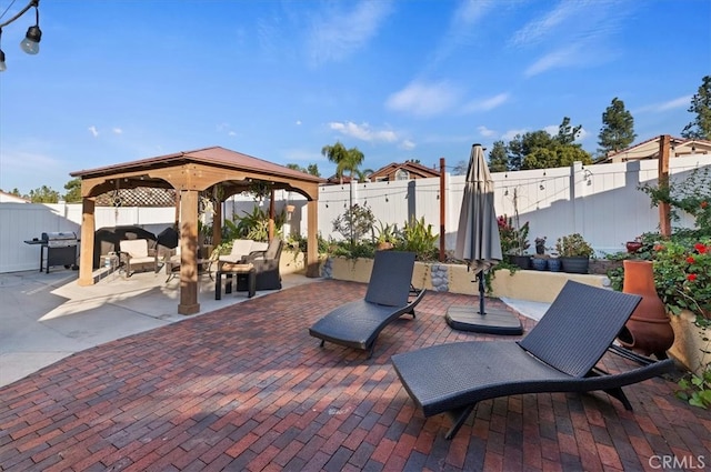 view of patio with a fenced backyard, a gazebo, and area for grilling