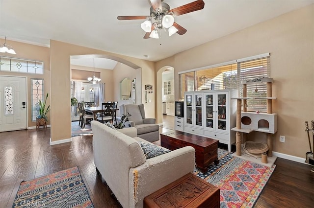 living room with wood-type flooring, arched walkways, and baseboards