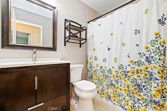 full bathroom featuring a shower with shower curtain, vanity, toilet, and tile patterned floors