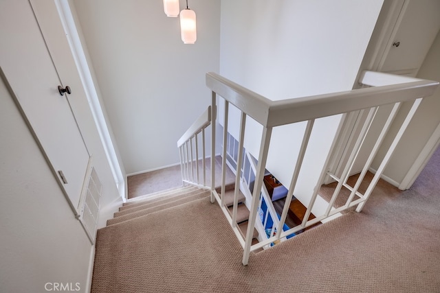 staircase with carpet and baseboards