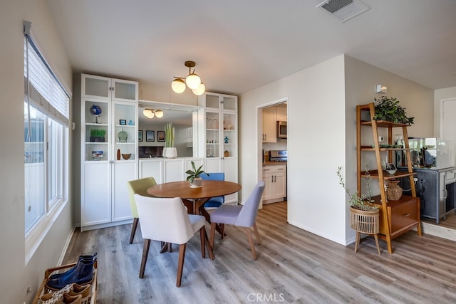 dining room with visible vents and light wood-style floors