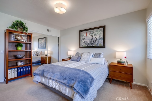 carpeted bedroom with baseboards and visible vents