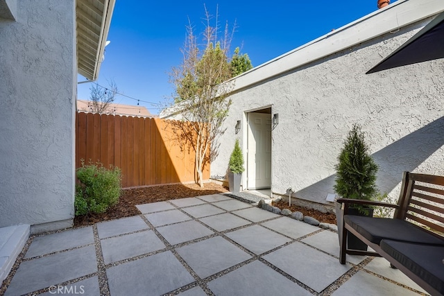 view of patio / terrace featuring fence