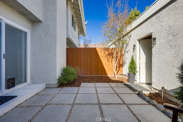 view of patio featuring fence