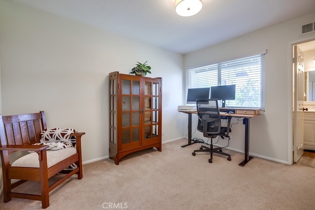 home office with light carpet and baseboards