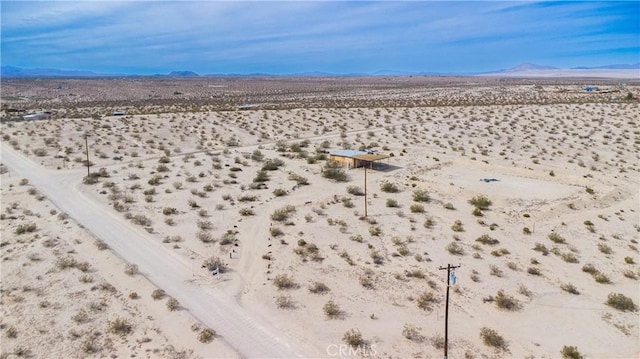 birds eye view of property with a mountain view, a desert view, and a rural view