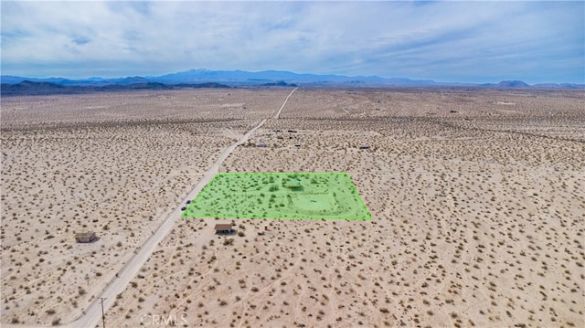 birds eye view of property featuring a rural view, a desert view, and a mountain view