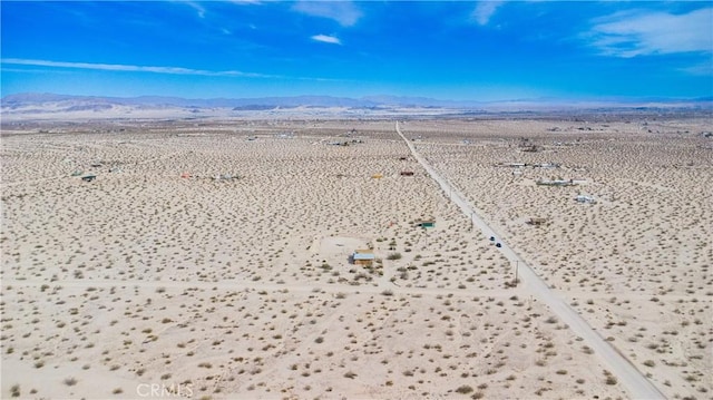 drone / aerial view with view of desert, a rural view, and a mountain view