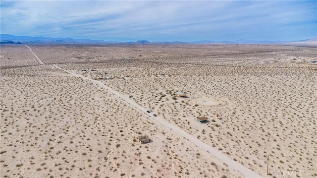 drone / aerial view with view of desert and a mountain view