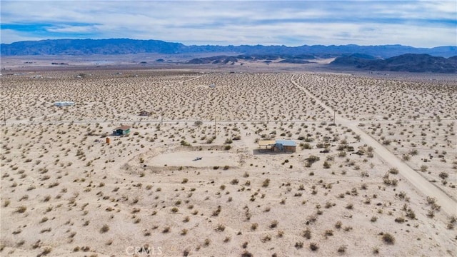 birds eye view of property featuring a rural view, a desert view, and a mountain view