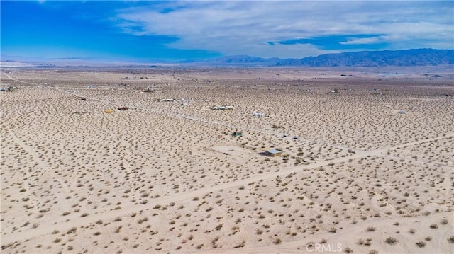 aerial view featuring a desert view and a mountain view