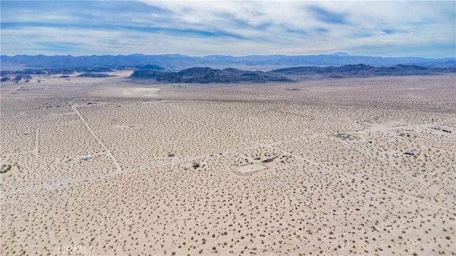 birds eye view of property with a mountain view and view of desert