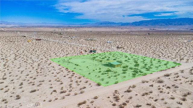 birds eye view of property with a rural view, a mountain view, and view of desert