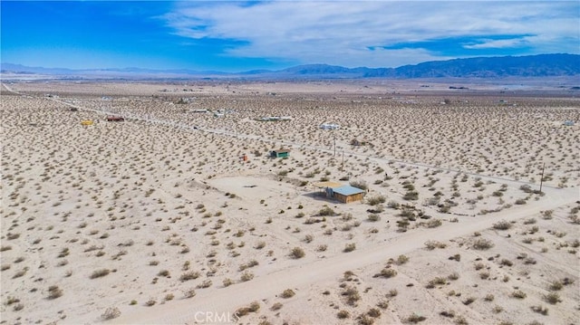 birds eye view of property featuring view of desert, a rural view, and a mountain view