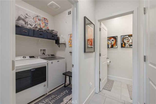 laundry room featuring visible vents, light tile patterned flooring, washer and dryer, laundry area, and baseboards