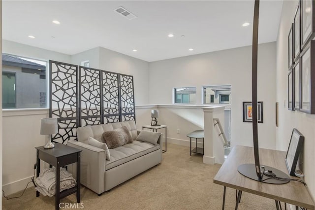 living area featuring light carpet, baseboards, visible vents, and recessed lighting