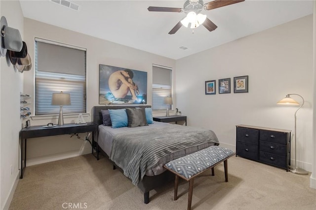 carpeted bedroom featuring ceiling fan, visible vents, and baseboards