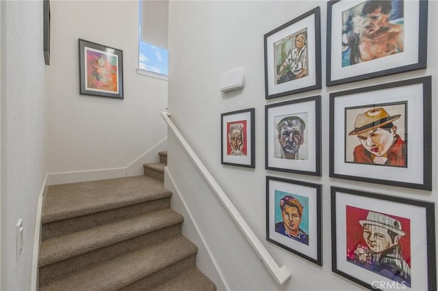 staircase featuring baseboards