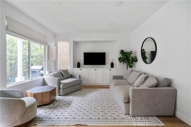 living area featuring light wood-style flooring and baseboards