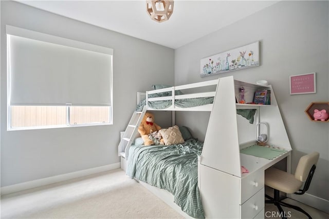 bedroom featuring carpet and baseboards